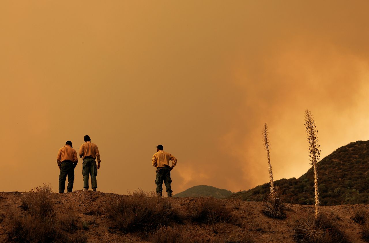 US Forest Service firefighters monitor a large plume from the Line Fire in the San Bernardino National Forest in California on September 9.