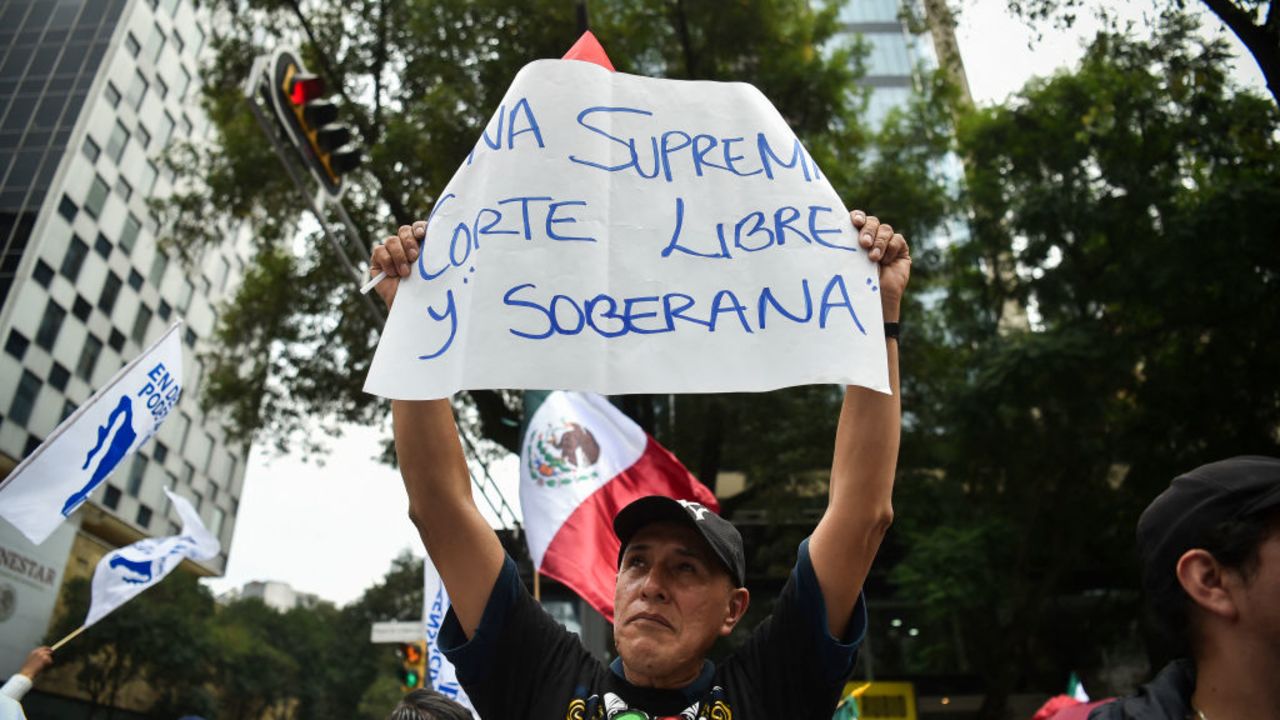 An employee of the judiciary takes part in a protest against the judicial reform proposed by the government in Mexico City on September 10, 2024. Mexican President Andres Manuel Lopez Obrador's controversial reform, which proposes the popular election of judges and magistrates, began its final stage in the Senate on Tuesday amid protests, tensions with the United States, and economic nervousness. (Photo by Rodrigo Oropeza / AFP) (Photo by RODRIGO OROPEZA/AFP via Getty Images)