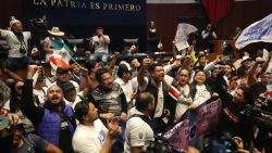 TOPSHOT - Demostrators take part in a protest inside the legislature's upper house during the legislation of the judicial reform proposed by the government at the National Congress in Mexico City on September 10, 2024. The Mexican Senate called for a session in an alternate venue to debate President Andres Manuel Lopez Obrador's controversial judicial reform after protesters invaded the legislative precinct and forced the suspension of deliberations, the chamber announced. (Photo by Silvana FLORES / AFP) (Photo by SILVANA FLORES/AFP via Getty Images)