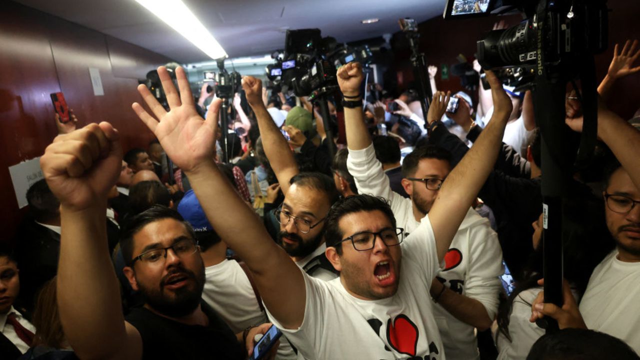 Demostrators take part in a protest inside the legislature's upper house during the legislation of the judicial reform proposed by the government at the National Congress in Mexico City on September 10, 2024. The Mexican Senate called for a session in an alternate venue to debate President Andres Manuel Lopez Obrador's controversial judicial reform after protesters invaded the legislative precinct and forced the suspension of deliberations, the chamber announced. (Photo by Silvana FLORES / AFP) (Photo by SILVANA FLORES/AFP via Getty Images)