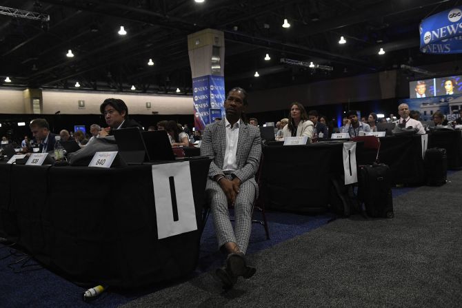 Members of the media watch the debate from the nearby spin room in Philadelphia.