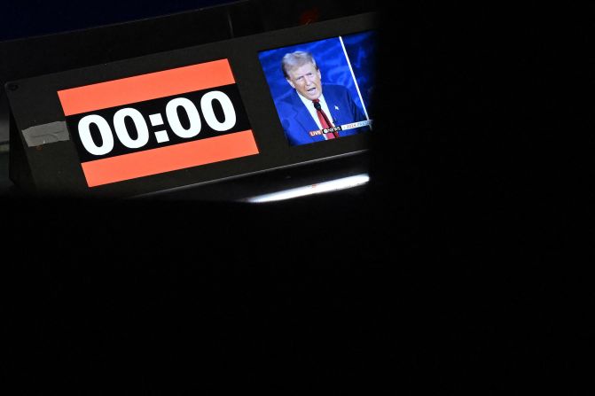 Trump appears on a screen next to the debate's countdown clock.