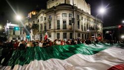 TOPSHOT - Judiciary workers and students hold a giant flag as they block the streets near the former headquarters of the Senate of Mexico, known as Casona de Xicotencatl, during a protest in Mexico City on September 10, 2024. Mexico's Senate on September 11 approved a constitutional reform to allow voters to elect judges, the chamber announced, after protesters had earlier forced lawmakers to suspend debate on the proposal. The reform was approved with 86 votes in favor and 41 against, making Mexico the world's only country to elect all of its judges. (Photo by Rodrigo Oropeza / AFP) (Photo by RODRIGO OROPEZA/AFP via Getty Images)