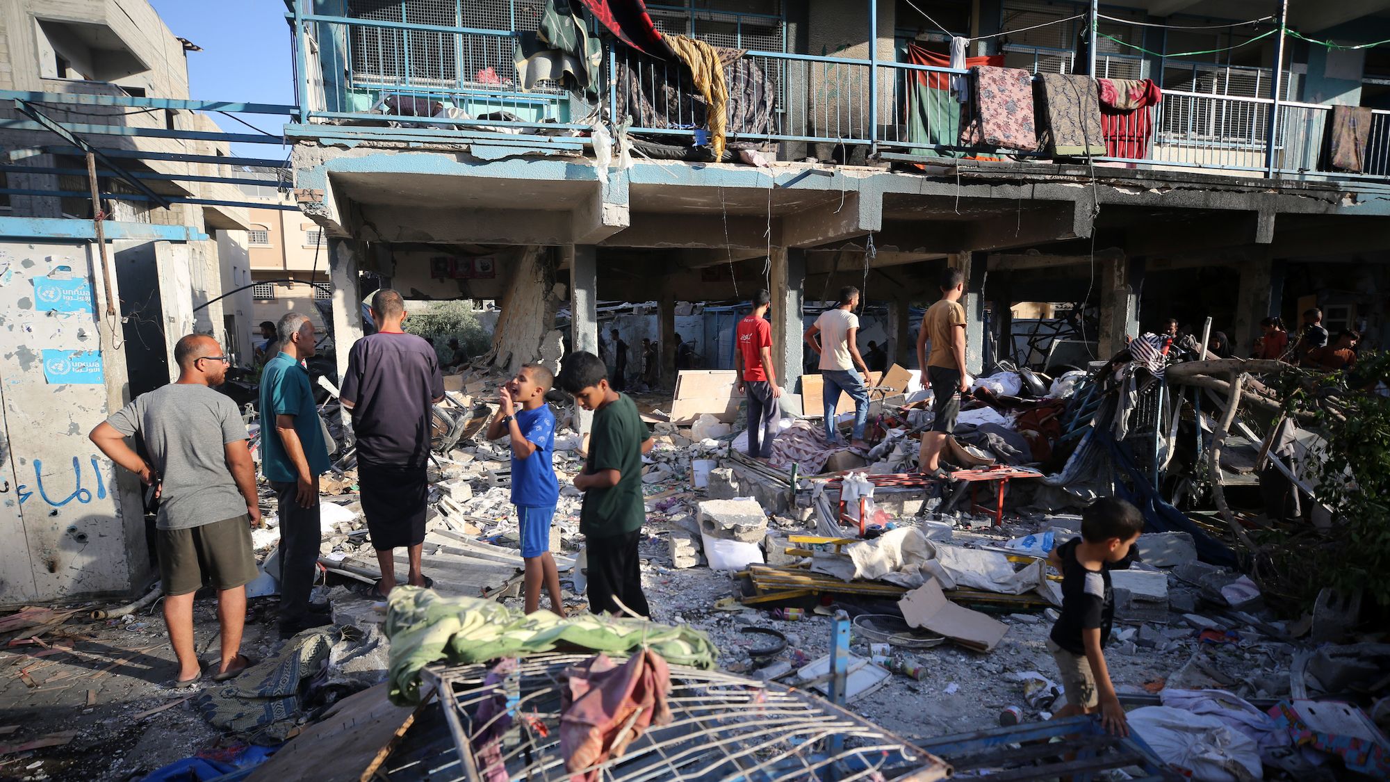 Palestinians check the grounds of a school after an Israeli airstrike in Nuseirat, Gaza Strip, on September 11, 2024.