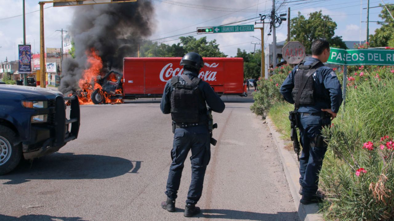 A truck on fire is seen on the streets of Culiacan, Sinaloa State, Mexico, on September 11, 2024. Elements of Mexico's National Guard were deployed in the state of Sinaloa, in the northwest of the country, amid an escalation of violence that authorities attribute to internal struggles within the Sinaloa cartel following the capture of its leader, Ismael "Mayo" Zambada. (Photo by Ivan MEDINA / AFP) (Photo by IVAN MEDINA/AFP via Getty Images)