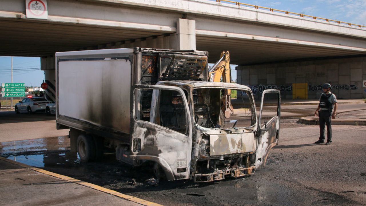 A burned truck is seen on the streets of Culiacan, Sinaloa State, Mexico, on September 11, 2024. Elements of Mexico's National Guard were deployed in the state of Sinaloa, in the northwest of the country, amid an escalation of violence that authorities attribute to internal struggles within the Sinaloa cartel following the capture of its leader, Ismael "Mayo" Zambada. (Photo by Ivan MEDINA / AFP) (Photo by IVAN MEDINA/AFP via Getty Images)