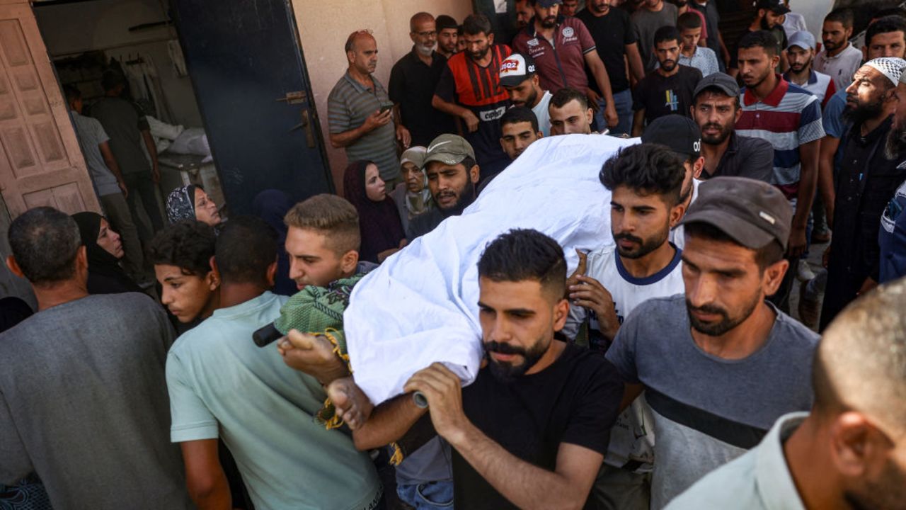 EDITORS NOTE: Graphic content / Mourners carry the body of a man who was killed by Israeli bombardment on the Jawni (Jaouni) school in Nuseirat the previous day, during his funeral in Deir el-Balah in the central Gaza Strip on September 12, 2024 amid the ongoing war in the Palestinian territory between Israel and Hamas. (Photo by Eyad BABA / AFP) (Photo by EYAD BABA/AFP via Getty Images)