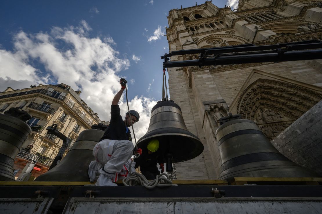 A worker installs the clapper onto "Marcel," one of the eight bells of Notre-Dame's north belfry in September.