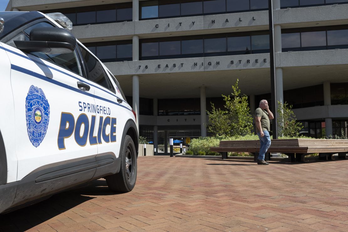 A man walks past Springfield City Hall after bomb threats were made against buildings earlier in the day in Springfield, Ohio on Sept. 12, 2024. A government building and a school were evacuated after an alleged bomb threat was made in Springfield, Ohio on Thursday, local media reported, rocking the small city at the heart of an anti-migrant conspiracy theory amplified by Donald Trump. Springfield has been in the spotlight in recent days after an unsubstantiated story about Haitian migrants eating pets went viral on social media, with the Republican ex-president and current White House candidate pushing the story despite it being debunked. (Photo by ROBERTO SCHMIDT / AFP) (Photo by ROBERTO SCHMIDT/AFP via Getty Images)