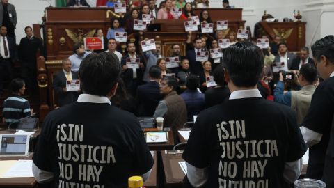 Deputies wearing t-shirts that read in Spanish "Without justice, there is no future!" are seen during the local vote in the Congress of Mexico City on the Judicial Reform in Mexico City on September 12, 2024. Mexican President Andrés Manuel López Obrador announced on Thursday that his controversial judicial reform, which provides for the election of all judges by popular vote, is ready to be enacted after winning the  of 18 state congresses. (Photo by Silvana FLORES / AFP) (Photo by SILVANA FLORES/AFP via Getty Images)