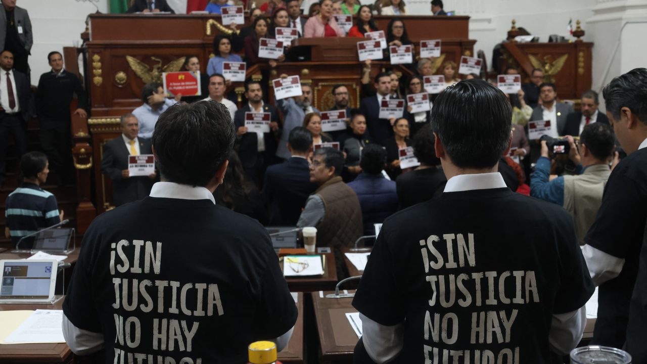 Deputies wearing t-shirts that read in Spanish "Without justice, there is no future!" are seen during the local vote in the Congress of Mexico City on the Judicial Reform in Mexico City on September 12, 2024. Mexican President Andrés Manuel López Obrador announced on Thursday that his controversial judicial reform, which provides for the election of all judges by popular vote, is ready to be enacted after winning the  of 18 state congresses. (Photo by Silvana FLORES / AFP) (Photo by SILVANA FLORES/AFP via Getty Images)
