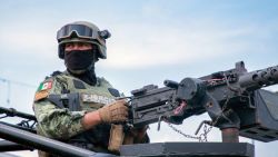 EDITORS NOTE: Graphic content / A member of the Mexican Army stands guard after an armed attack against the facade of a business selling new and pre-owned cars in Culiacán, Sinaloa State, Mexico, on September 12, 2024. Spiraling criminal violence, much of it linked to drug trafficking and gangs, has seen more than 450,000 people murdered in Mexico since 2006. (Photo by Ivan MEDINA / AFP) (Photo by IVAN MEDINA/AFP via Getty Images)