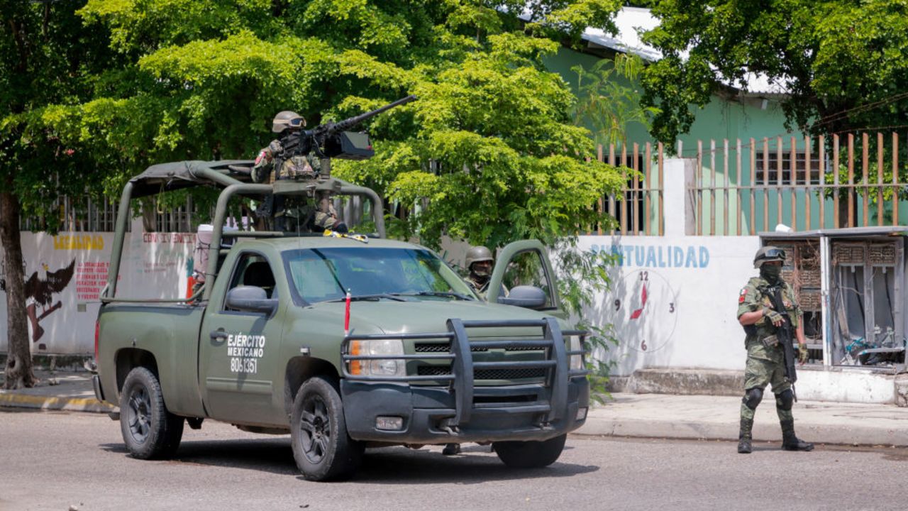 EDITORS NOTE: Graphic content / Members of the Mexican Army stand guard after an armed attack against the facade of a business selling new and pre-owned cars in Culiacán, Sinaloa State, Mexico, on September 12, 2024. Spiraling criminal violence, much of it linked to drug trafficking and gangs, has seen more than 450,000 people murdered in Mexico since 2006. (Photo by Ivan MEDINA / AFP) (Photo by IVAN MEDINA/AFP via Getty Images)