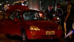 Police officers inspect the car of the director in charge of the Centro de Privación de Libertad Masculina N°1 del Guayas, María Daniela Icaza, after being attacked in Guayaquil, Ecuador, on 12 September 2024. The director of a prison in Guayaquil, Ecuador's largest and the scene of some of the worst inmate killings, was murdered on Thursday, becoming the second prison official to be killed in ten days, the agency in charge of prisons (SNAI) said. (Photo by MARCOS PIN / AFP) (Photo by MARCOS PIN/AFP via Getty Images)