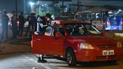 A police officer inspects the car of the director in charge of the Centro de Privación de Libertad Masculina N°1 del Guayas, María Daniela Icaza, after being attacked in Guayaquil, Ecuador, on 12 September 2024. The director of a prison in Guayaquil, Ecuador's largest and the scene of some of the worst inmate killings, was murdered on Thursday, becoming the second prison official to be killed in ten days, the agency in charge of prisons (SNAI) said. (Photo by MARCOS PIN / AFP) (Photo by MARCOS PIN/AFP via Getty Images)