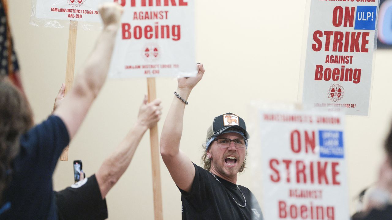 TOPSHOT - Union members react as Jon Holden, president of Aerospace Machinists District 751 (off-screen), announces that union members have rejected a proposed Boeing contract and will go on strike, following the voting results at their union hall in Seattle, Washington, on September 12, 2024 Boeing Seattle-area workers voted overwhelmingly to strike on September 12, rejecting a contract that the embattled airline giant characterized as a boon to workers given the company's strained financial state. (Photo by Jason Redmond/AFP) (Photo by JASON REDMOND/AFP via Getty Images)