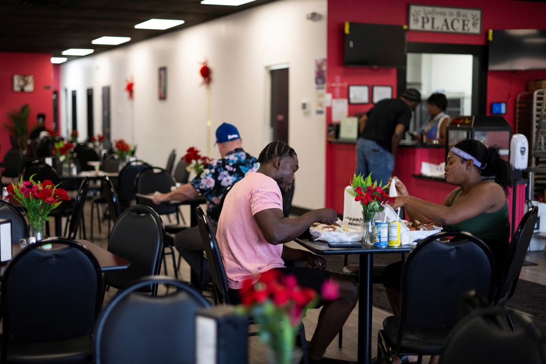 Haitians sit down to eat their meal at a Haitian restaurant in Springfield, Ohio, on September 12, 2024.