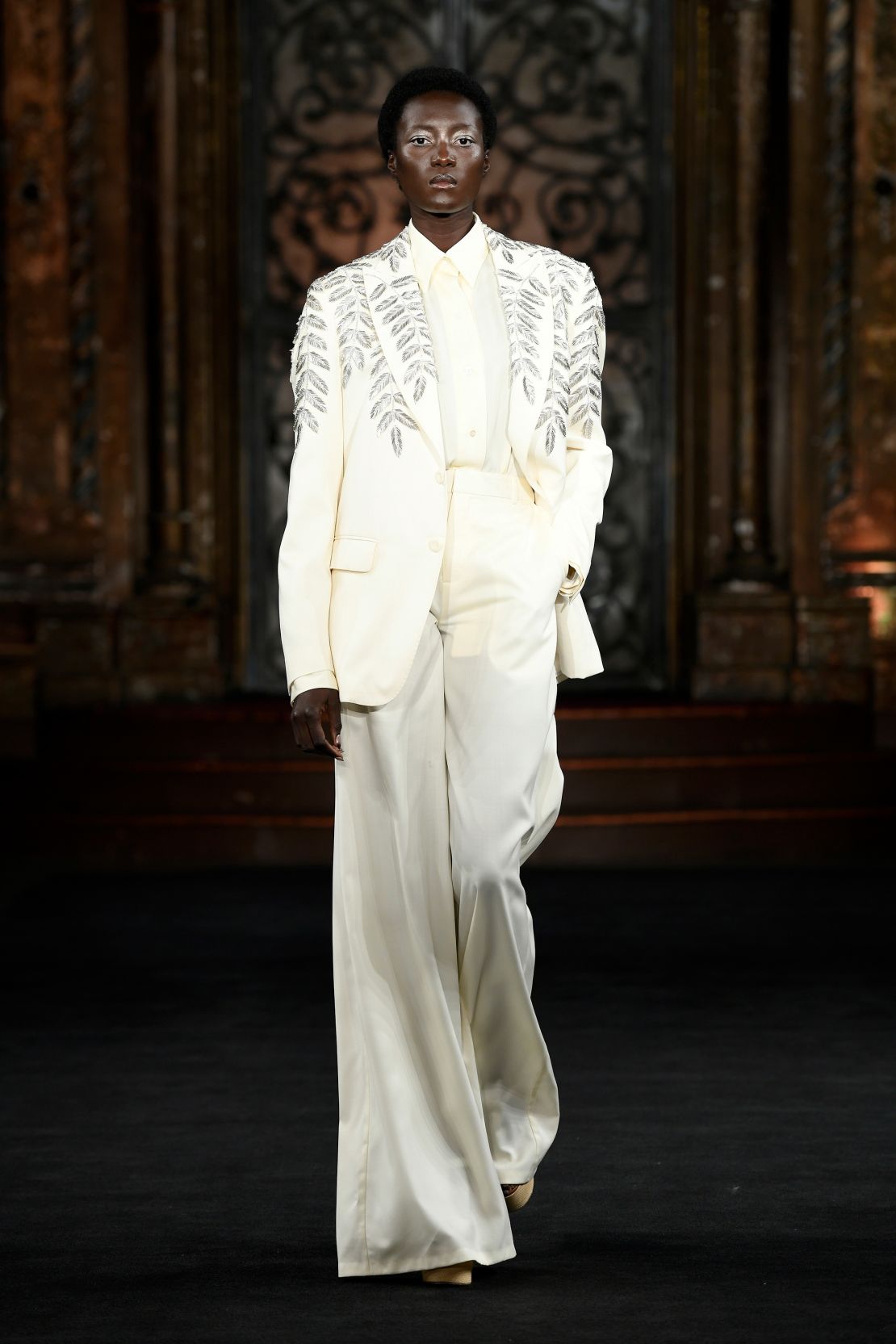 Naeem Kahn’s first collection was inspired by Sicilian Baroque architecture and included breezy suits in addition to his signature glittering dresses.