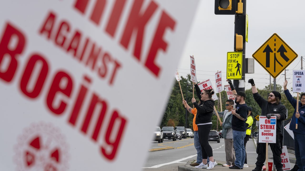 Workers with picket signs outside the Boeing Co. manufacturing facility.
