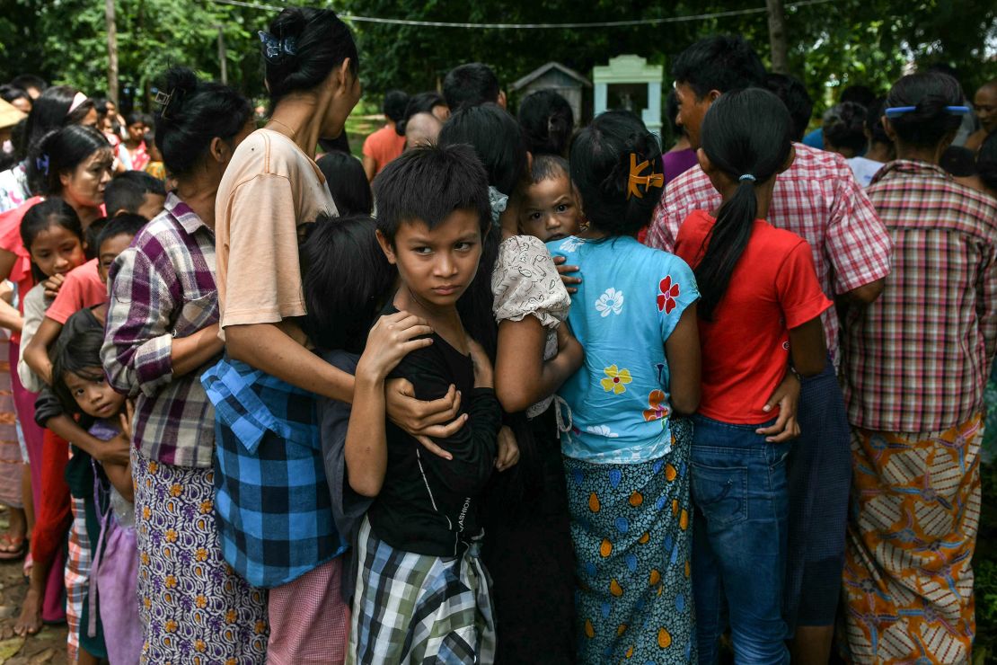 Flood-affected residents line up for food at a temporary camp in Taungoo, Myanmar, on September 14, 2024.