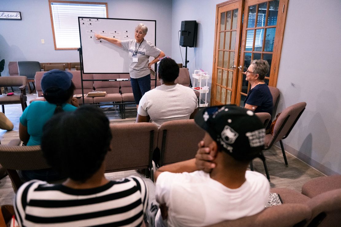 Volunteer teacher Hope Kaufman leads Haitian students during an English class at the Haitian Community Outreach and Support Center in Springfield on Sept. 13.