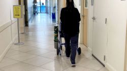 Hospital hallway with nurse pushing empty wheelchair with oxygen, Jupiter Medical Center, Florida. (Photo by: Lindsey Nicholson/UCG/Universal Images Group via Getty Images)