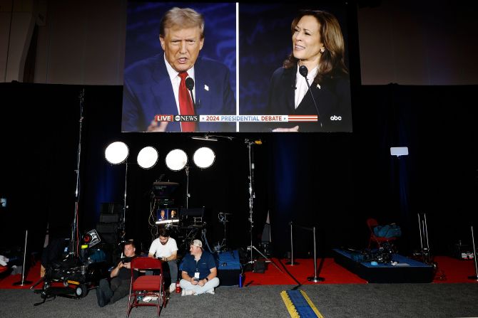 The debate is seen on a screen at the Pennsylvania Convention Center, which was the site of the debate "spin room" in Philadelphia. The spin room is where supporters of each candidate put their “spin” on the debate as they talk with journalists.