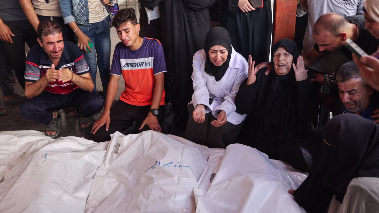 Palestinians mourn over the the bodies of a family killed by an Israeli bombardment in Gaza City on September 15.
