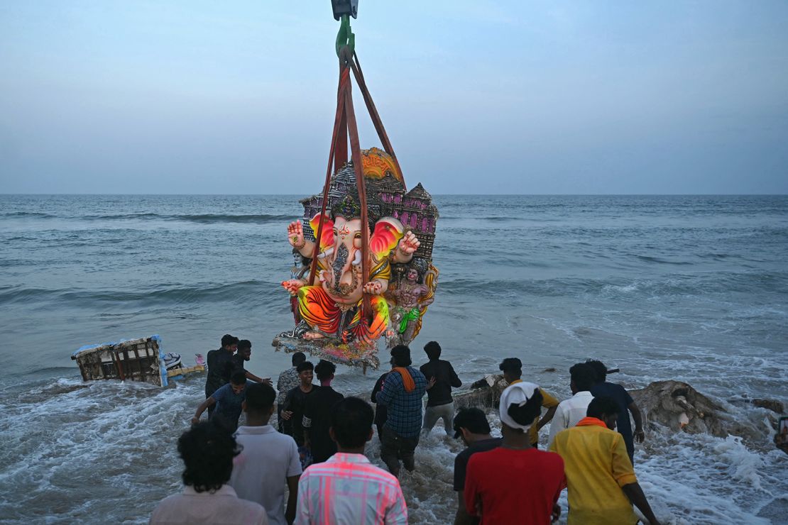 Devotees use a crane to immerse an idol of the Hindu deity Ganesha in the Bay of Bengal during the Ganesh Chaturthi festival in Chennai on September 15, 2024.