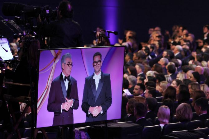 Show hosts Eugene and Dan Levy are seen on a monitor at the Peacock Theater.