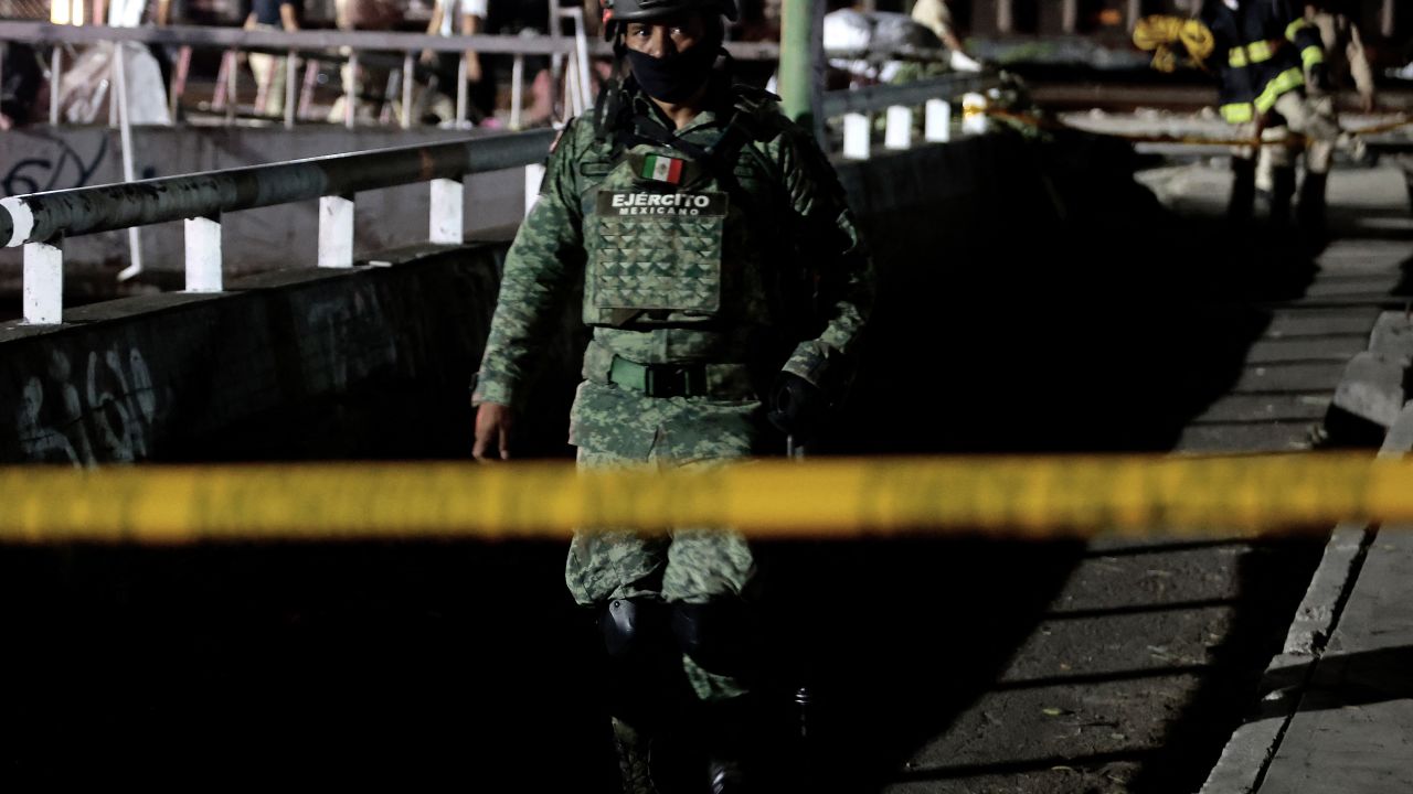 A Mexican soldier walks in the area where three bodies were found tied up inside the cars of a train that crosses Guadalajara, Jalisco state, Mexico, on September 17, 2024. The northbound freight train that crosses the city of Guadalajara also carries migrants from Mexico and Central America heading to the United States in search of work. (Photo by ULISES RUIZ / AFP) (Photo by ULISES RUIZ/AFP via Getty Images)