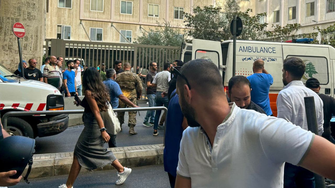 People react near an ambulance as the wounded are brought to a hospital in Beirut on September 17, 2024, after explosions hit locations in several Hezbollah strongholds around Lebanon amid ongoing cross-border tensions between Israel and Hezbollah fighters. Hundreds of people were wounded when Hezbollah members' paging devices exploded simultaneously across Lebanon on September 17, in what a source close to the militant movement said was an "Israeli breach" of its communications. (Photo by Anwar AMRO / AFP) (Photo by ANWAR AMRO/AFP via Getty Images)