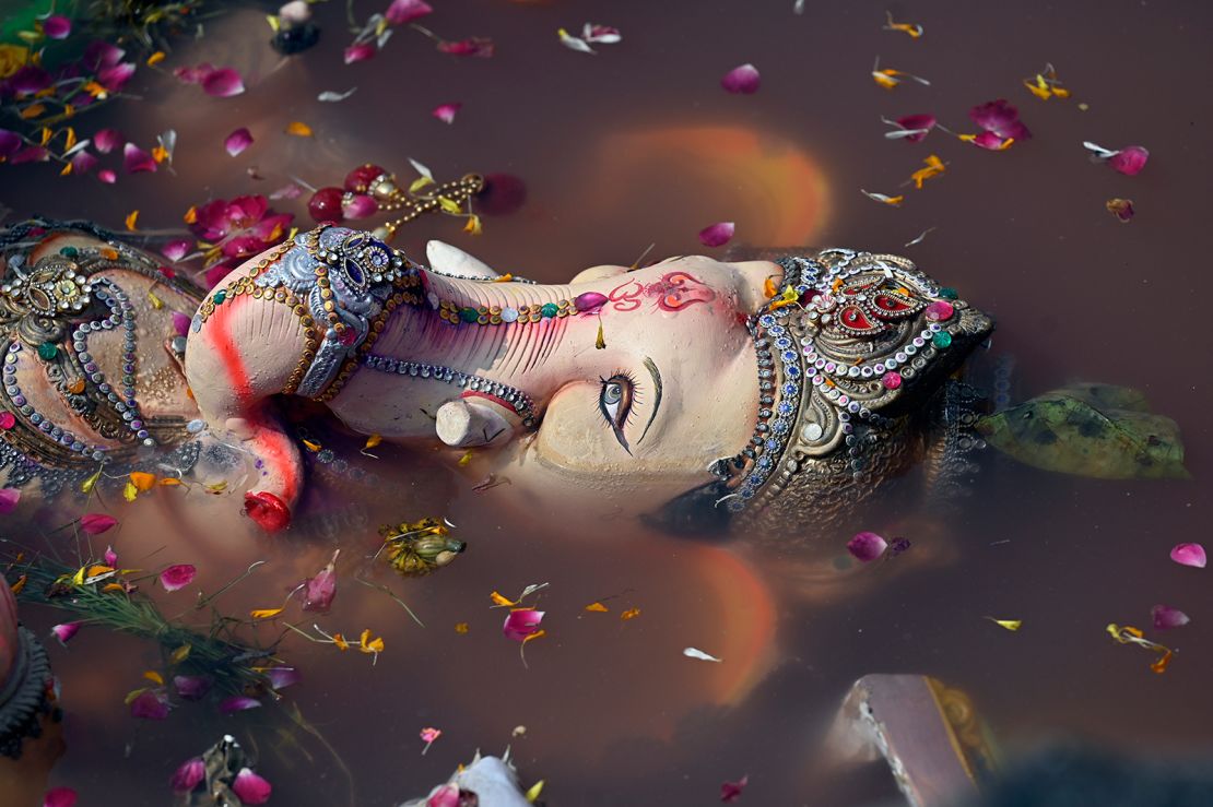 An idol of Lord Ganesha is immersed in a water pond created by the Delhi Government on the last day of the Ganesh Chaturthi festival, at Geeta Colony in New Delhi, India on September 17, 2024.