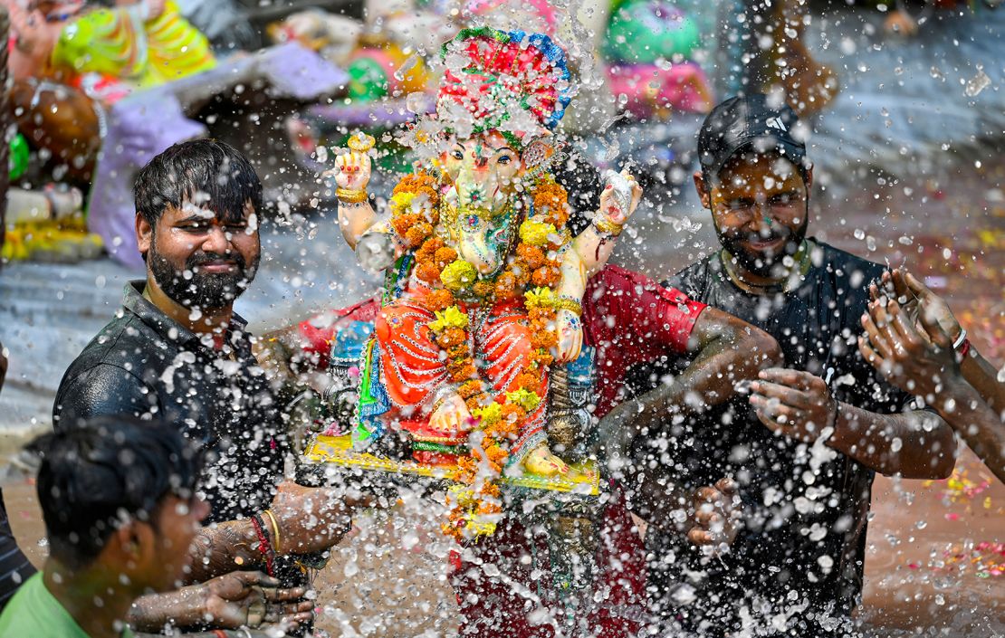 Devotees immerse an idol of Lord Ganesh in the water pond created by the Delhi Government on the last day of the Ganesh Chaturthi festival, at Geeta Colony in New Delhi, India on September 17, 2024.