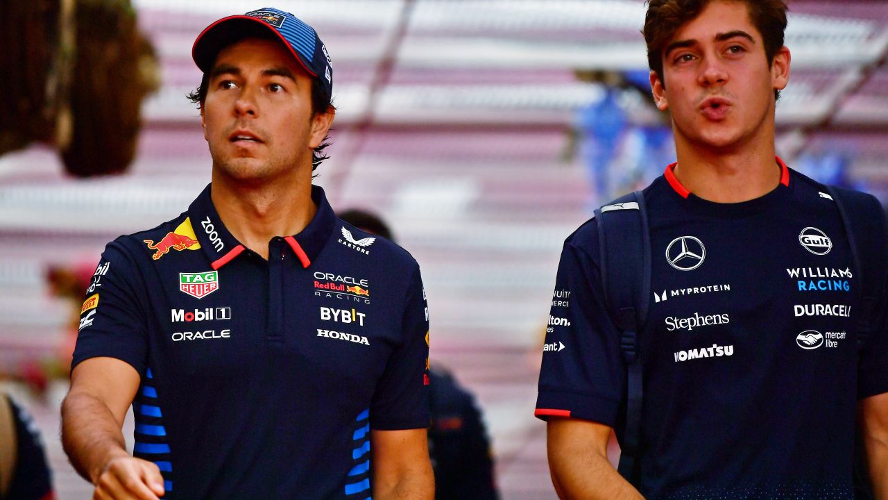 BAKU, AZERBAIJAN - SEPTEMBER 14: Sergio Perez of Mexico and Oracle Red Bull Racing and Franco Colapinto of Argentina and Williams walk in the Paddock prior to final practice ahead of the F1 Grand Prix of Azerbaijan at Baku City Circuit on September 14, 2024 in Baku, Azerbaijan. (Photo by James Sutton/Getty Images)