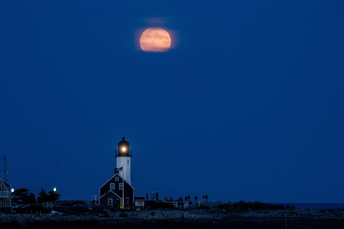 The harvest moon, a full supermoon, shines over Scituate Lighthouse in Scituate, Massachusetts, on Tuesday.