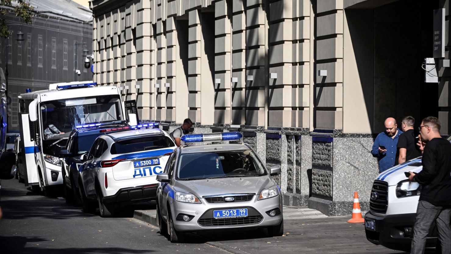 Russian police officers stand guard outside the office building of Russian retailer Wildberries after an attempted raid in central Moscow on September 18.