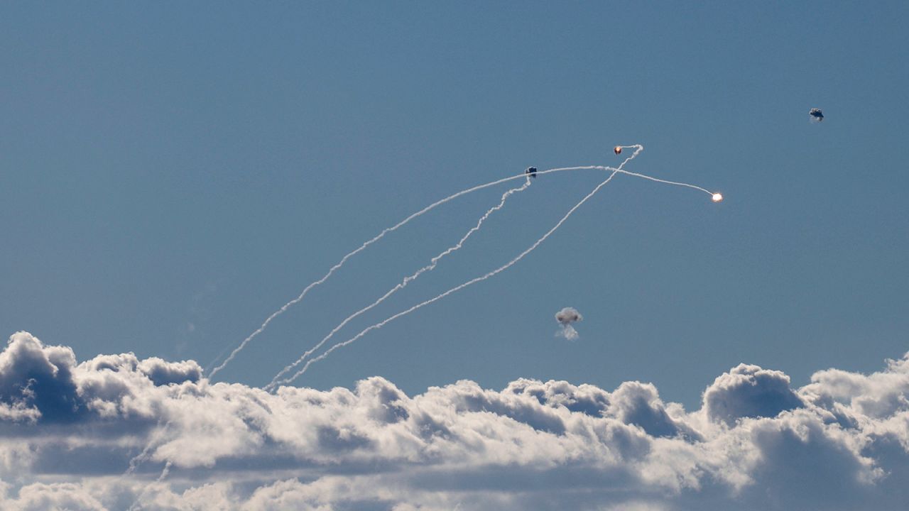 Rockets fired from southern Lebanon are intercepted by Israel's Iron Dome air defence system over the Upper Galilee region in northern Israel on September 18, 2024.