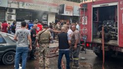 People and first responders gather at the scene of a reported device explosion in Saida in southern Lebanon on September 18, 2024. A second wave of device explosions killed three people in Hezbollah strongholds of Lebanon on September 18, raising fears of an all-out war between Israel and the Iran-backed militants. (Photo by Mahmoud ZAYYAT / AFP) (Photo by MAHMOUD ZAYYAT/AFP via Getty Images)