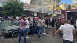 people gather as fire fighters put out the fames at the scene of a reported device  explosion in saida in southern lebanon on september 18, 2024. a second wave of device explosions killed three people in hezbollah strongholds of lebanon on september 18, raising fears of an all-out war between israel and the iran-backed militants. (photo by mahmoud zayyat / afp) (photo by mahmoud zayyat/afp via getty images)