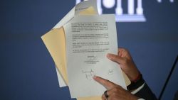 The president of the National Assembly Jorge Rodriguez shows the alleged letter and signature from opposition candidate Edmundo Gonzalez Urrutia during a press conference at the National Assembly in Caracas on September 18, 2024. The Venezuelan government released an alleged letter from Gonzalez Urrutia, in which he informed authorities of his decision to seek asylum in Spain and said he would 'abide by' the court ruling that validated the re-election of President Nicolás Maduro. Gonzalez Urrutia's lawyer José Vicente Haro said that Gonzalez 'has not signed any document recognising the election results'. (Photo by Federico PARRA / AFP) (Photo by FEDERICO PARRA/AFP via Getty Images)