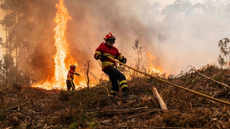 Fire fighters tackle a wildfire in the Aveiro region of Portugal, on Wednesday, Sept. 18, 2024. Firefighters are battling blazes in the region of Aveiro and other areas of northern Portugal for a fourth day after temperatures increased earlier this week. Photographer: Jose Sarmento Matos/Bloomberg via Getty Images
