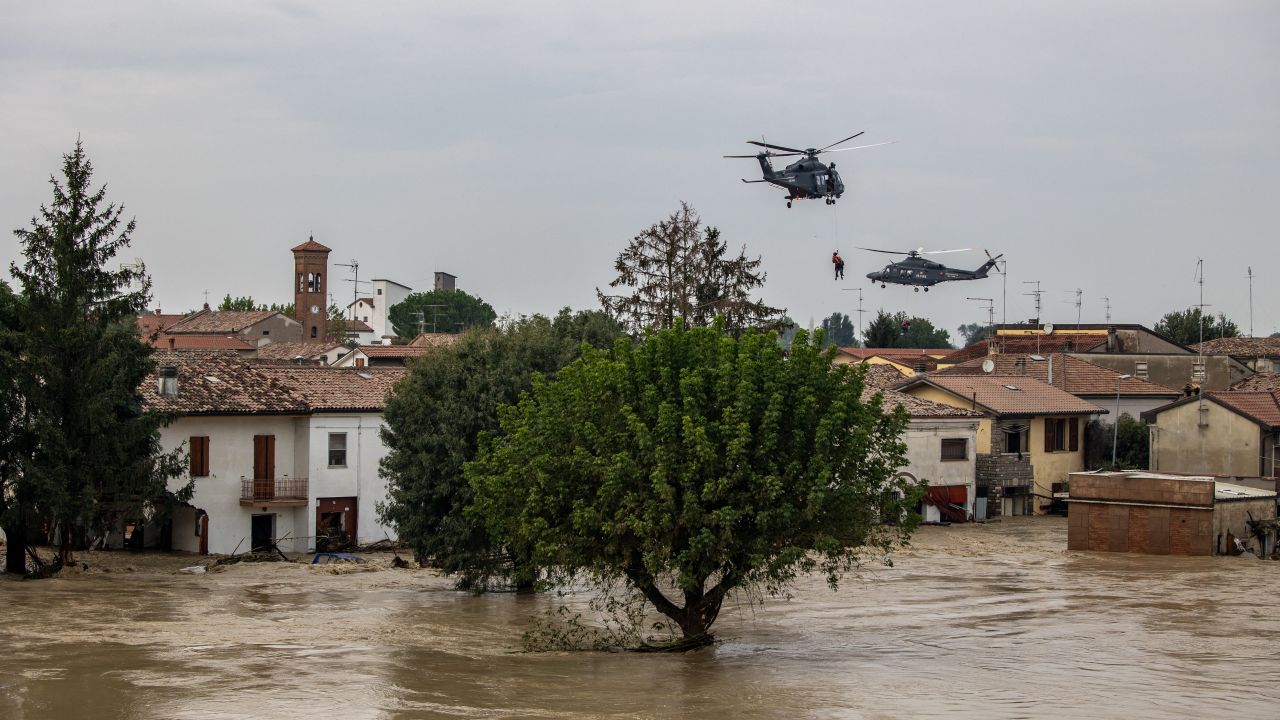 TOPSHOT - People are evacuated by helicopters of the Italian Air Force during floods in the small village of Traversara, on September 19, 2024. Many inhabitants were caught by the flood are still stuck in their homes sourrounded by water. The strong winds and rains which have swept across central and eastern Europe, killing 24 people, pummeled the Emilia-Romagna and Marche regions, with over 1,000 people evacuated from homes. (Photo by Federico SCOPPA / AFP) (Photo by FEDERICO SCOPPA/AFP via Getty Images)