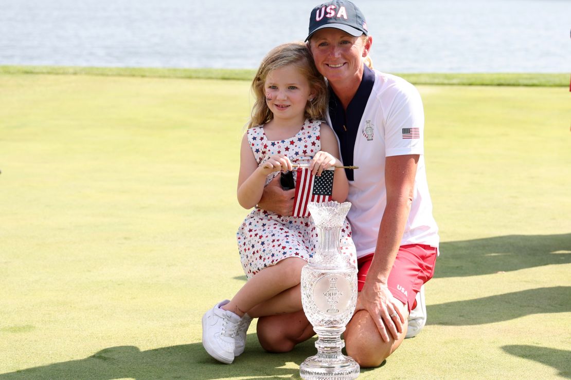 Lewis and her daughter pose with the trophy.