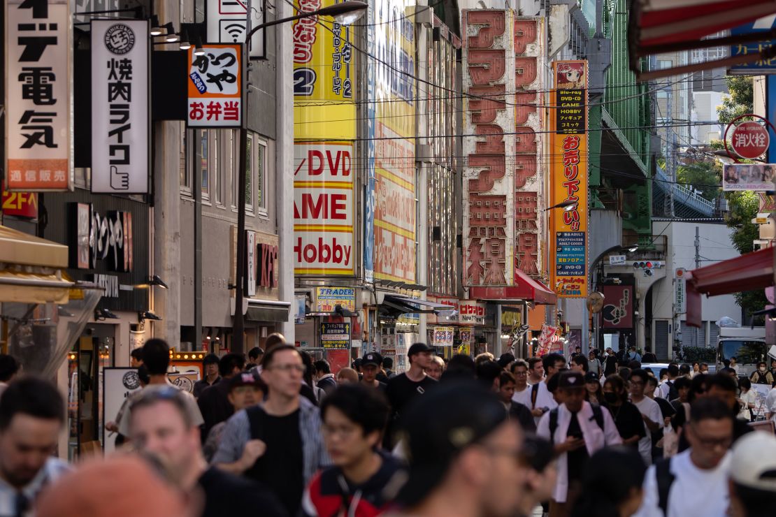 People walk through Tokyo's Akihabara district, famous for its abundant electronics, anime, manga and gaming products.