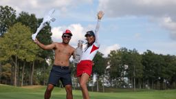 GAINESVILLE, VIRGINIA - SEPTEMBER 15: Alison Lee of Team United States poses with the Solheim Cup and caddie after winning during the final round of the Solheim Cup 2024 at Robert Trent Jones Golf Club on September 15, 2024 in Gainesville, Virginia. (Photo by Scott Taetsch/Getty Images)