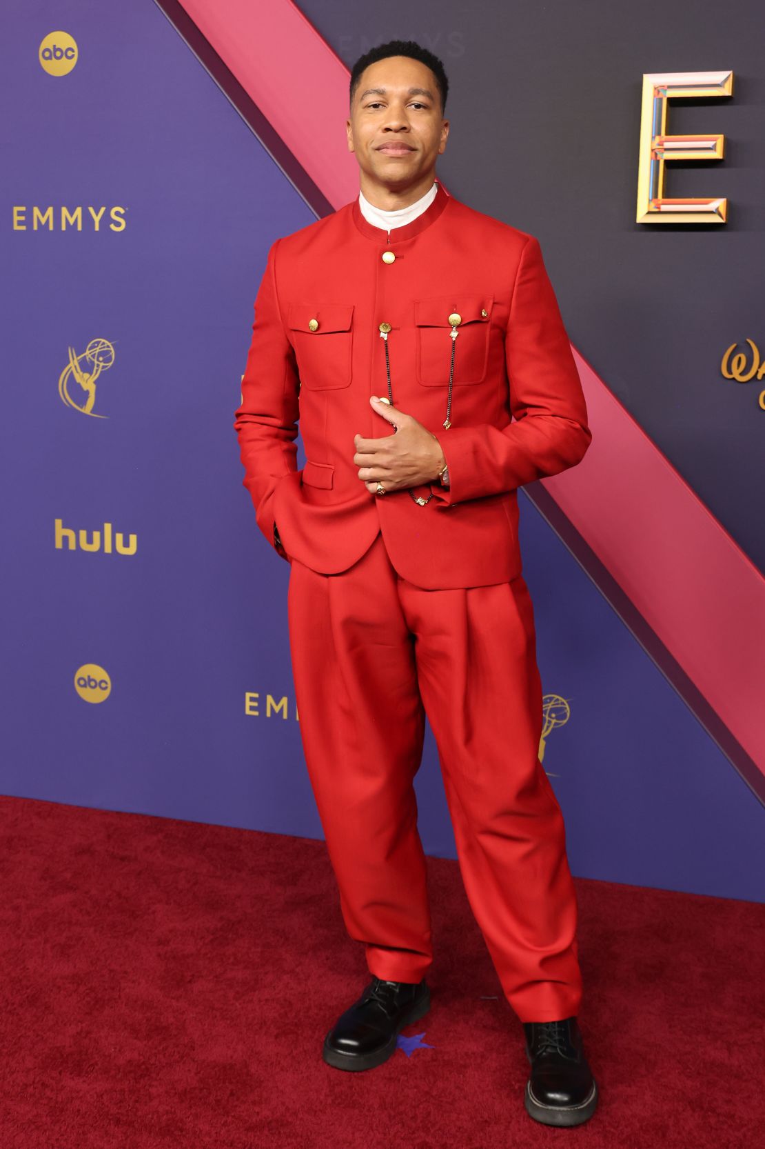 Aaron Moten in a bright red Kenzo suit.