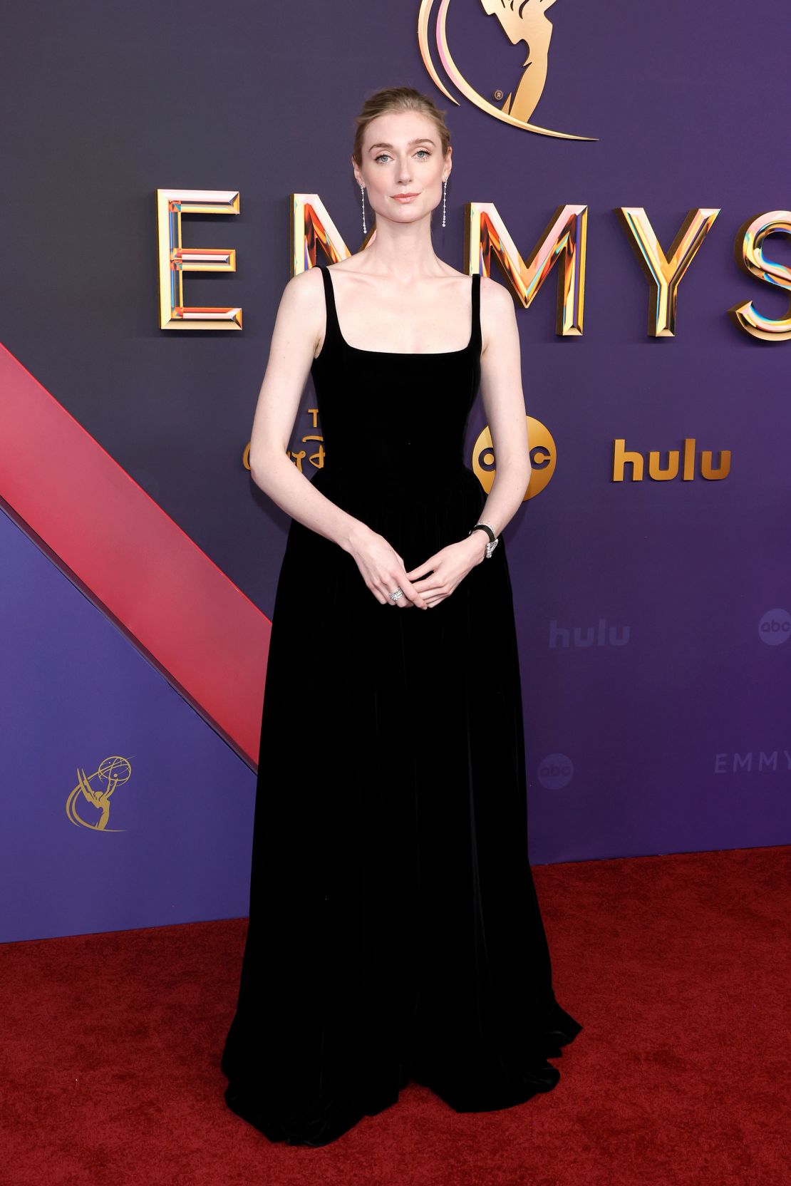 Elizabeth Debicki wears a long velvet dress by Dior.