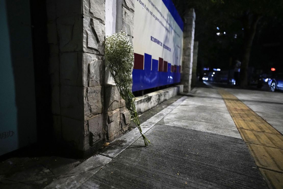 White flowers are placed at the location where the boy was fatally stabbed.