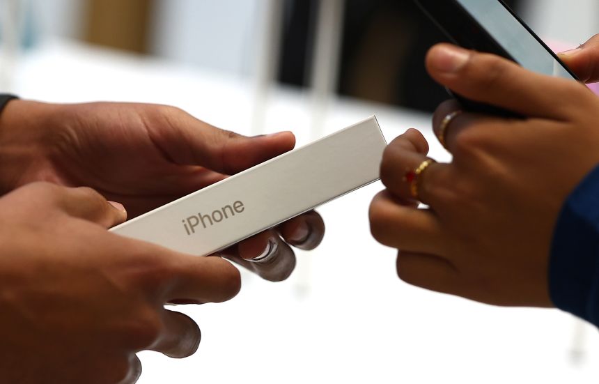 A customer purchases a new Apple iPhone 16 at the Apple Store, Regent Street on September 20, 2024 in London, England. F